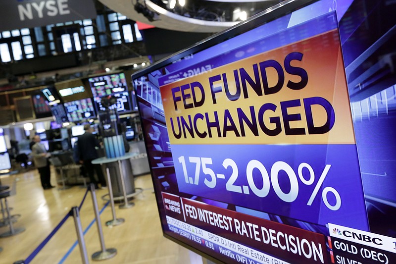 A screen on the floor of the New York Stock Exchange shows the rate decision of the Federal Reserve, Wednesday, Aug. 1, 2018. The Federal Reserve is leaving its benchmark interest rate unchanged while signaling further gradual rate hikes in the months ahead as long as the economy stays healthy. (AP Photo/Richard Drew)