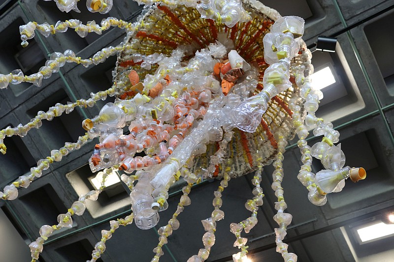 In this photo taken July 26, 2018, a giant jellyfish sculpture is viewed from below at the Audubon Aquarium of the Americas in New Orleans. The sculpture, made from fishing buoys and cut-up water bottles that washed up on the Pacific Coast, is among six placed around the aquarium. (AP Photo/Janet McConnaughey)