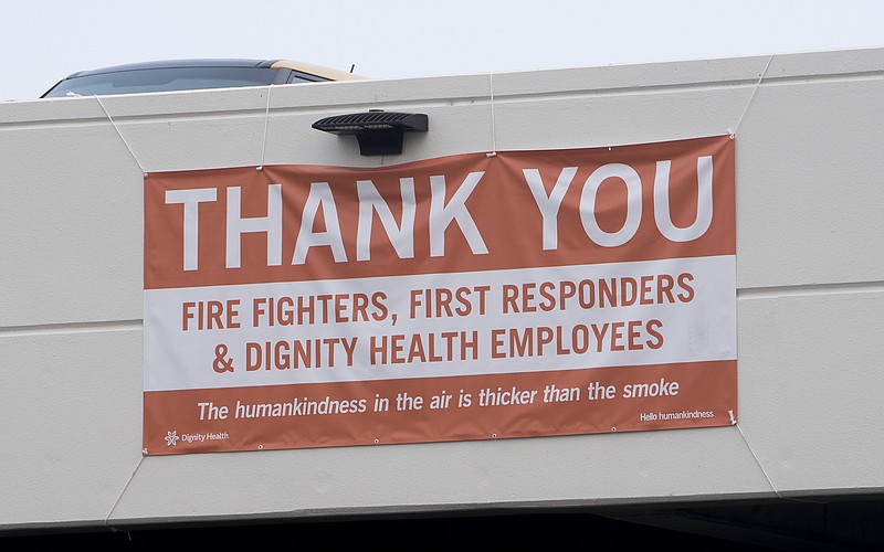 In this photo taken Thursday, Aug. 2, 2018, a thank you banner for fire fighters, first responders and hospital workers hangs outside Mercy Medical Center in Redding, Calif. Dozens of staff members, including doctors, nurses and others at the medical center are keeping the hospital running despite losing their homes to the flames. (AP Photo/Michael Burke)