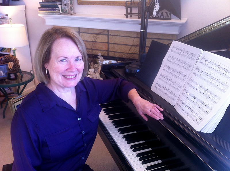 Pianist Judy Buttles at one of her two grand pianos. "I don't think the word 'miracle' should be used lightly, but there is no other word to describe what happened," she said. (Lucy Luginbill/Tri-City Herald/TNS)