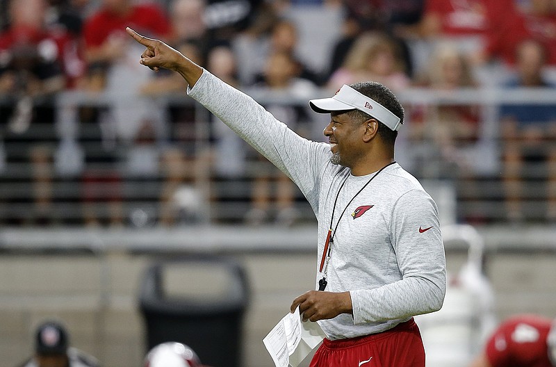 Arizona Cardinals coach Steve Wilks smiles as he points to a coach during NFL football training camp Thursday, Aug. 2, 2018, in Glendale, Ariz. (AP Photo/Ross D. Franklin)
