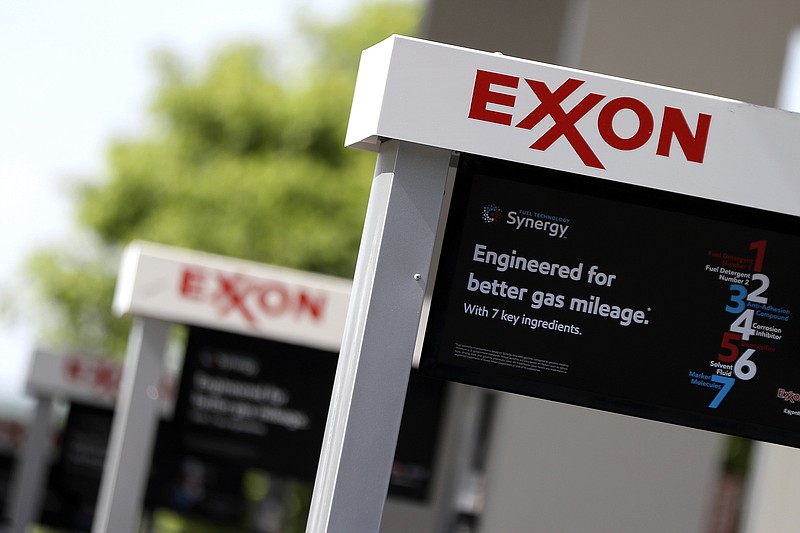 File-This April 25, 2017, file photo, shows Exxon service station signs in Nashville, Tenn. The Trump administration has dropped a two-year investigation into how Exxon Mobil Corp. factors climate-change regulations into how it calculates the value of its assets. The Securities and Exchange Commission informed the energy giant in a letter that it would not recommend an enforcement action against the company at this time. Exxon Mobil spokesman Scott Silvestri said on Friday, Aug. 3, 2018, that the company cooperated fully with the SEC inquiry. He says Exxon is confident its financial reporting meets all legal and accounting requirements. The SEC letter says its decision should not be construed as an exoneration. The agency declined further comment. (AP Photo/Mark Humphrey, File)