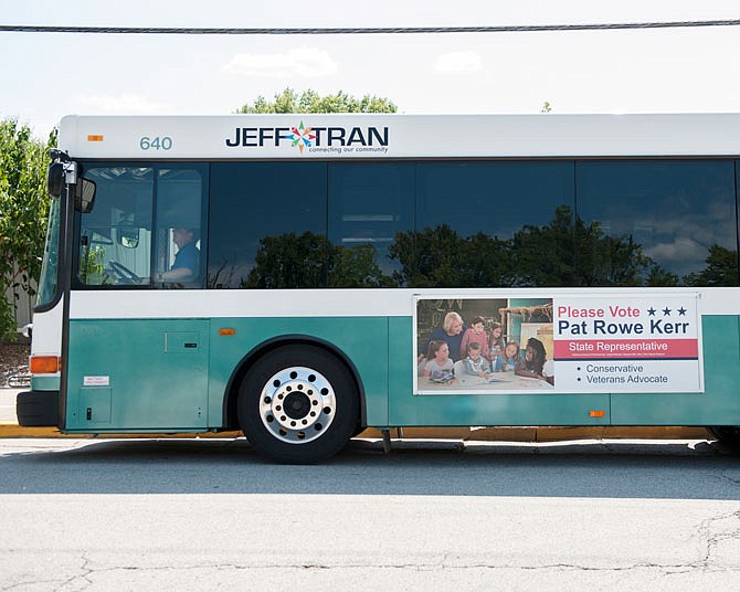 Several city buses sporting political advertisements for various political candidates stop Thursday at the Miller Street transfer station. A future city meeting will address whether some of the political ads on the city buses could be construed as endorsements from the city.