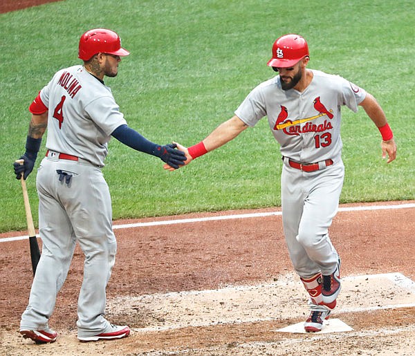 Matt Carpenter of the Cardinals is greeted by on-deck batter Yadier Molina after hitting a solo home run in the fifth inning of Sunday's game against the Pirates in Pittsburgh.
