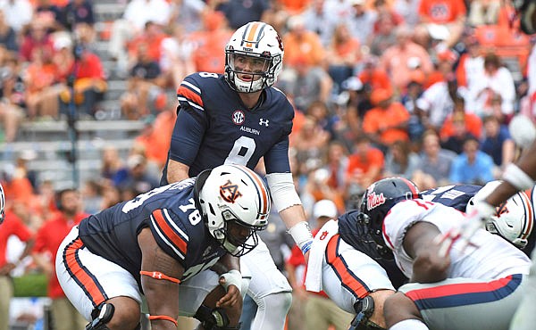 In this Oct. 7, 2017, file photo, Auburn quarterback Jarrett Stidham (center) looks to the sideline during the second half of a game against Mississippi in Auburn, Ala.