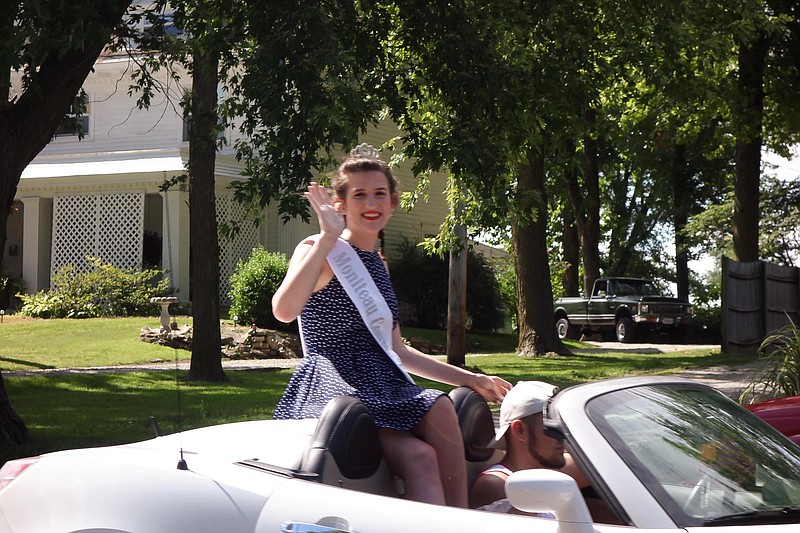 Emily Bilyeu, 2017 Miss Moniteau County, waves to the crowd during the Independence Day parade.