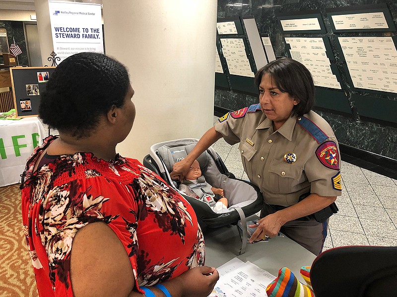 Sylvia Jennings with the Texas Department of Safety demonstrates proper car seat restraint Tuesday evening at Wadley Regional Medical Center's second annual Breastfeeding Celebration. (Submitted photo)
