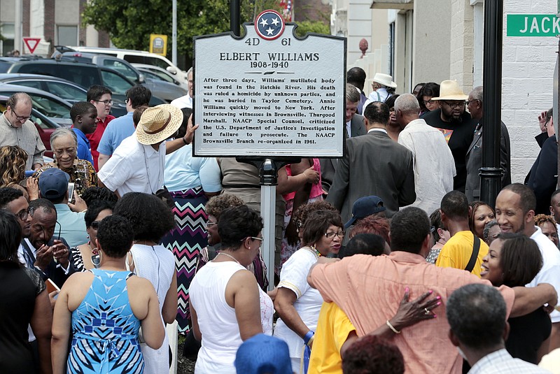 FILE - In this Saturday, June 20, 2015 file photo, people inspect a historical marker honoring Elbert Williams after it was unveiled near the town square in Brownsville, Tenn.  Haywood County DA Garry Brown said Wednesday, Aug. 8, 2018 that his office is launching an investigation into the death of Williams, whose body was found in a river in Brownsville in June 1940, three days after the 32-year-old civil rights worker was taken from his home by a group of men led by a police officer. (AP Photo/Mark Humphrey, File)