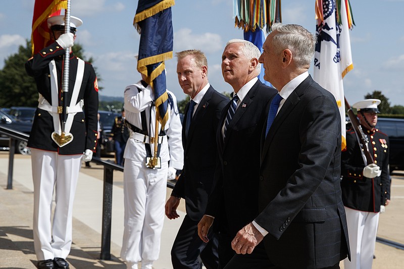 Vice President Mike Pence, center, is greeted by Deputy Secretary of Defense Pat Shanahan, left, and Secretary of Defense Jim Mattis before speaking at an event on the creation of a United States Space Force, Thursday, Aug. 9, 2018, at the Pentagon. (AP Photo/Evan Vucci)