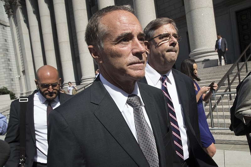 Republican U.S. Rep. Christopher Collins, center, leaves federal court, Wednesday, Aug. 8, 2018, in New York. Rep. Collins of western New York state has been indicted on charges that he used inside information about a biotechnology company to make illicit stock trades (AP Photo/Mary Altaffer)