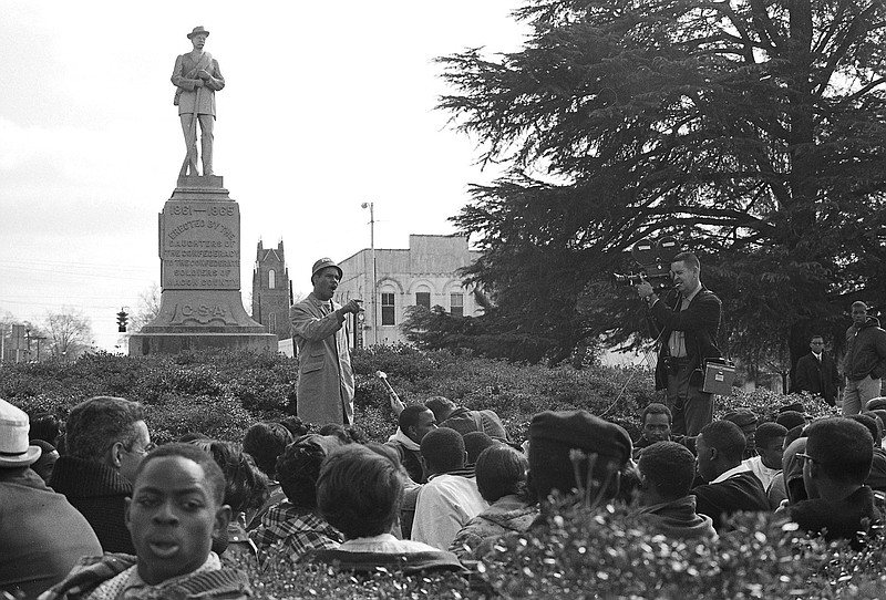 This undated photo provided by the Alabama Department of Archives and History, from 1966 shows Frank Toland, a professor at what is now called Tuskegee University, speaking to protesters gathered around the Confederate monument in Tuskegee, Alabama. Demonstrators protesting the shooting death of a black man later attempted to pull down the monument, which remains in the mostly black city. (James Peppler/Alabama Department of Archives and History via AP)