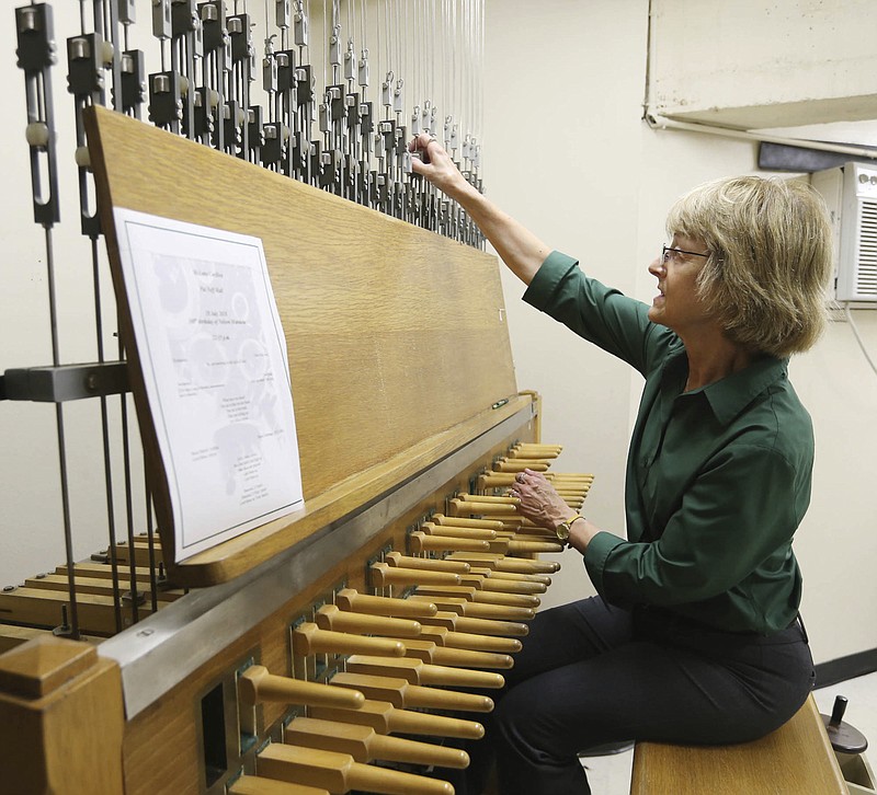 In this Wednesday, July 18, 2018 photo, Baylor University carillonneur Lynnette Geary fine tunes her organ before performing high atop at Pat Neff Hall, in Waco, Texas. The instrument includes 22 tons of bronze bells at the top of the administration building near the center of campus. (Rod Aydelotte/Waco Tribune Herald, via AP)