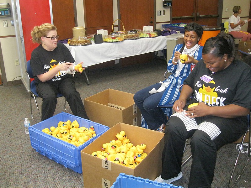 From left, Kelly Cowly, Jacoya Anderson and Tonya Anderson work with nearly 20 other volunteers in labeling about 12,000 rubber ducks Thursday at CHRISTUS St. Michael Health Center in preparation for the Great Texarkana Duck Race. The race will be Aug. 18 at Holiday Springs Water Park, 5500 Crossroads Parkway, Texarkana, Ark. Ducks can be adopted for $5 each. For $25, five ducks can be adopted, with a sixth one free. Adoptions can be made online at christusstmichaelfoundation.org or by calling 903-614-7223 until 4:30 p.m. Aug. 17. Proceeds will benefit 3D mammography services at the St. Michael Imaging Center.