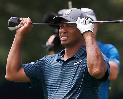 Tiger Woods watches to his second shot on the eighth hole during Thursday's first round of the PGA Championship at Bellerive Country Club in St. Louis.