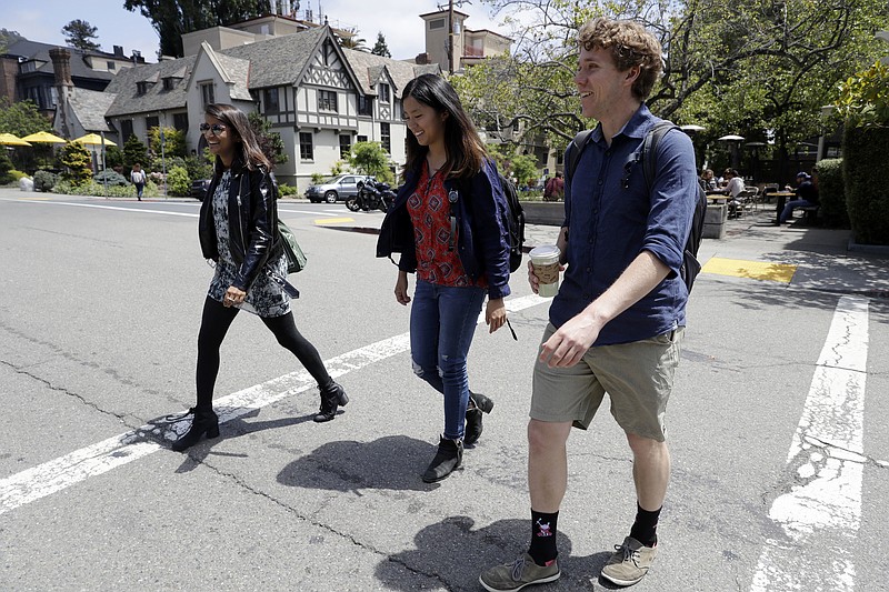 University of California students, from left, Anjali Banerjee, Alice Ma and Tyler Heintz walk near the university's campus Wednesday, June 6, 2018, in, Berkeley, Calif. The students who were in Nice, France when a terrorist drove a truck down a promenade killing 83 people, including one of their classmates, have channeled their grief and anger into two nonprofits to fight terrorism.  (AP Photo/Marcio Jose Sanchez)