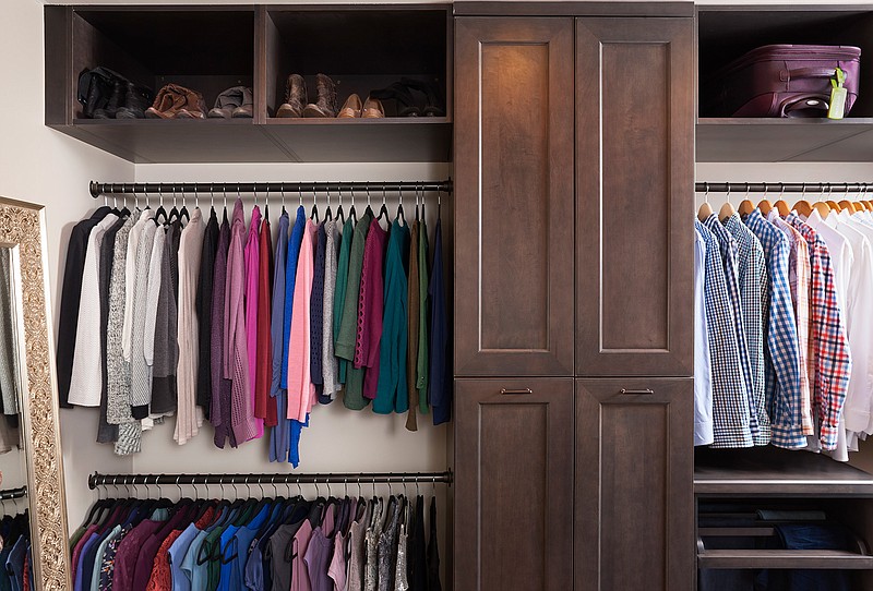This photo provided by Case Design shows a closet designed by Elena Eskandari, an interior designer specialist at Case Design. As you plan out a walk-in closet, consider the size of the items you'll be hanging. This closet pictured has two levels of hanging space which offers room for a large collection of shirts and blouses. (Stacy Zarin Goldberg/Case Design via AP)