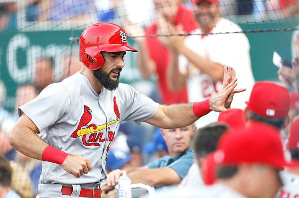 Matt Carpenter of the Cardinals is congratulated at the dugout after hitting a two-run home run in the second inning of Friday night's game against the Royals at Kauffman Stadium in Kansas City.