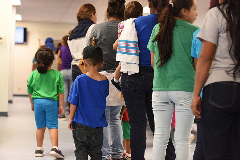In this Thursday, Aug. 9, 2018, photo, provided by U.S. Immigration and Customs Enforcement, mothers and their children stand in line at South Texas Family Residential Center in Dilley, Texas. Currently housing 1,520 mothers and their children, about 10 percent are families who were temporarily separated and then reunited under a "zero tolerance policy" that has since been reversed. (Charles Reed/U.S. Immigration and Customs Enforcement via AP)