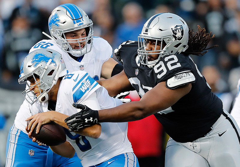 Detroit Lions quarterback Matt Cassel, left, is sacked by Oakland Raiders nose tackle P.J. Hall (92) during the first half of an NFL preseason football game in Oakland, Calif., Friday, Aug. 10, 2018. (AP Photo/John Hefti)