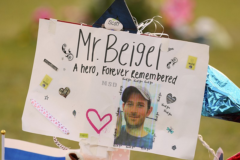 FILE - This Feb. 20, 2018, file photo shows a memorial for Geography teacher and cross-country coach, Scott Beigel at Pine Trails Park in Parkland, Fla. A street in New York's Long Island has been named for Beigel who helped shield students from the gunman in last winter's school shooting. The street where Beigel grew up in Dix Hills, N.Y., was dedicated "Scott J. Beigel Way" on Saturday Aug. 11. (Mike Stocker/South Florida Sun-Sentinel via AP, File)