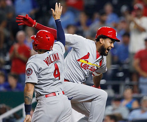 Jose Martinez of the Cardinals celebrates with Yadier Molina after hitting a two-run home run during the ninth inning of Saturday night's game at Kauffman Stadium.