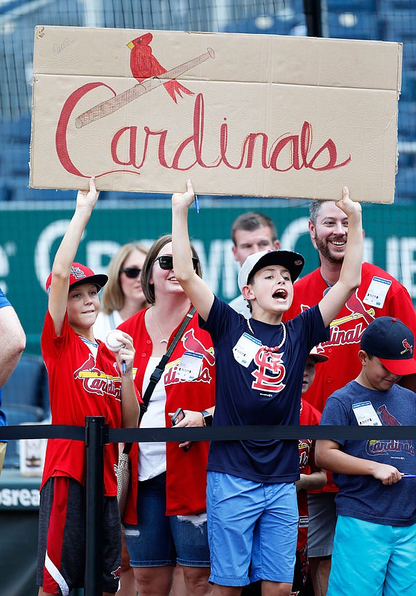 Young Cardinals fans seek autographs during the team's batting practice before Saturday's game against the Royals at Kauffman Stadium in Kansas City.