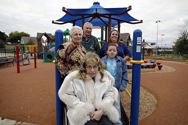 Clockwise from bottom center, Amber Tatro, her mother Mary Tatro, Joe Taylor, Becky Murphey and her daughter, Brianna Murphey, are pictured at Miracle Field, an athletic field and playground designed for use by disabled youth, in an October 2009 file image, Irving, Texas. (G.J. McCarthy/Dallas Morning News/TNS)