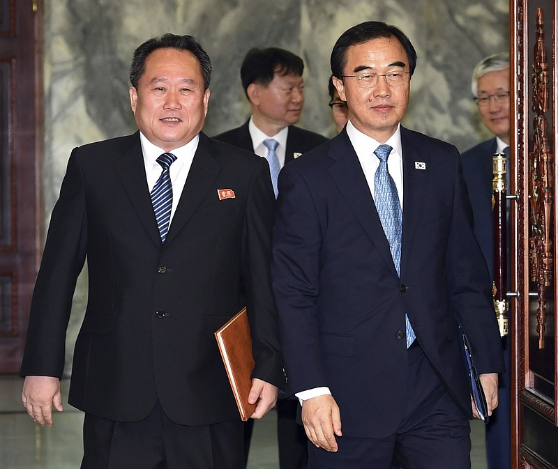 South Korean Unification Minister Cho Myoung-gyon, right, and his North Korean counterpart Ri Son Gwon arrive to hold their meeting at the northern side of Panmunjom in the Demilitarized Zone, North Korea, Monday, Aug. 13, 2018. Senior officials from the rival Koreas met Monday to set a date and venue for a third summit between South Korean President Moon Jae-in and North Korean leader Kim Jong Un, part of an effort to breathe new life into resolving the nuclear standoff between Washington and Pyongyang. (Korea Pool/Yonhap via AP)