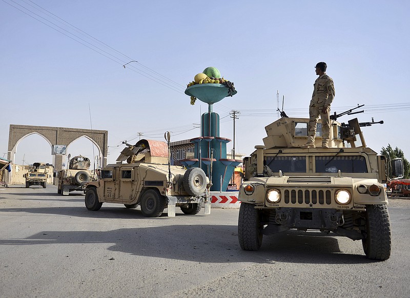 In this Sunday, Aug. 12, 2018, photo, Afghan security personnel patrol in the city of Ghazni province west of Kabul, Afghanistan.  A Taliban assault on Ghazni, a key city linking areas of Taliban influence barely 75 miles from Kabul, has killed about 100 Afghan policemen and soldiers since Friday, the Afghan Defense Ministry said. A year after the Trump administration introduced its strategy for Afghanistan, the Taliban are asserting themselves on the battlefield even as U.S. officials talk up hopes for peace. That’s raising questions about the viability of the American game plan for ending a war that began when some of the current U.S. troops were in diapers.  (AP Photo/Mohammad Anwar Danishyar)