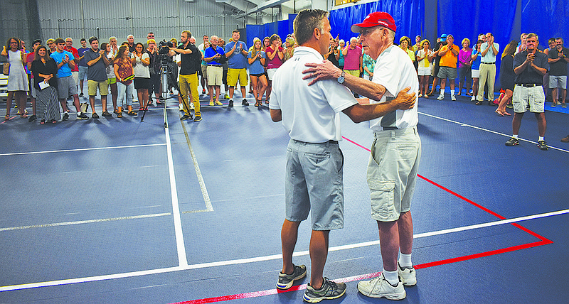 Jefferson City YMCA CEO Craig Lammers, left, introduces David Steinmeyer on Sunday after announcing the Firley YMCA named its tennis courts after Steinmeyer, a longtime tennis coach at the Y.