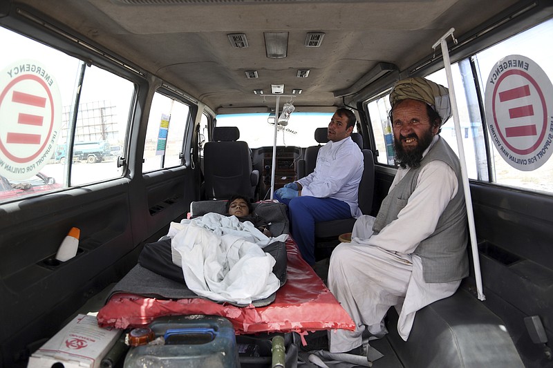 An injured boy rides in an ambulance on the Ghazni highway, in Maidan Shar, west of Kabul, Afghanistan, Monday, Aug. 13, 2018. Afghan forces battled the Taliban in the eastern city of Ghazni a key provincial capital, for the fourth straight day on Monday, following a massive assault on the eastern city last week that overwhelmed its defenses and allowed insurgents to capture several parts of it, officials said. (AP Photo/Rahmat Gul)