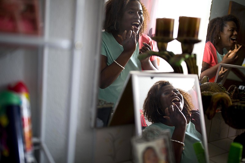 Yaisah Val a transgender woman get her makeup done at her home in Port-au-Prince, Haiti, on July 12, 2018. Val recently came out publicly as a transgender woman on YouTube, a potentially risky move in a country like Haiti where LGBT residents face pervasive hostility in most spheres of public life. (AP Photo/Dieu Nalio Chery)