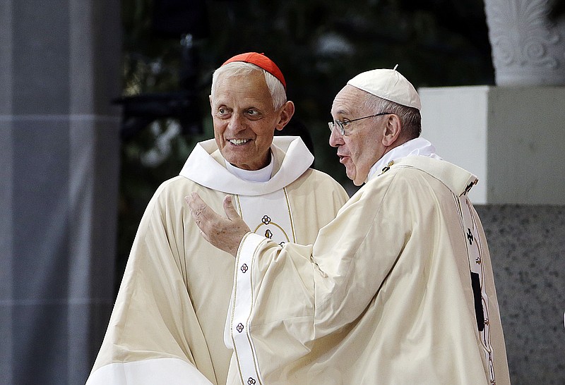 FILE – In this Sept. 23, 2015, file photo, Cardinal Donald Wuerl, archbishop of Washington, left, looks toward the crowd with Pope Francis following a Mass outside the Basilica of the National Shrine of the Immaculate Conception in Washington. Wuerl wrote to priests to defend himself on the eve of the scheduled Tuesday, Aug. 14, 2018, release of a grand jury report investigating child sexual abuse in six of Pennsylvania's Roman Catholic dioceses. (AP Photo/David Goldman, File)