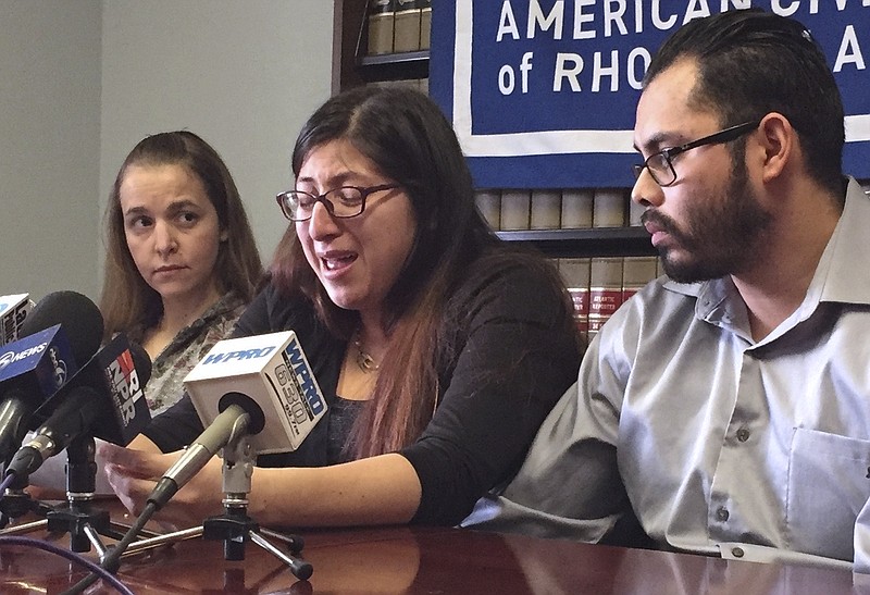FILE - In this Feb. 14, 2018, file photo, Lilian Calderon, center, cries as she describes her experiences while in custody, alongside her husband, Luis Gordillo, right, during a news conference at the office of the American Civil Liberties Union in Providence, R.I.   Gordillo is a U.S. citizen, but Calderon is a native of Guatemala who came to the country with her family at the age of 3. She was ordered to leave in 2002 after her father was denied asylum.  (AP Photo/Michelle R. Smith, File)