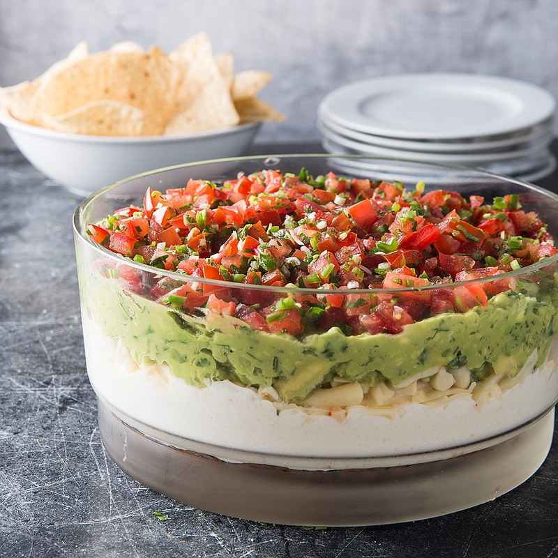 This undated photo provided by America's Test Kitchen in July 2018 shows ultimate seven layer dip in Brookline, Mass. This recipe appears in the cookbook "All-Time Best Appetizers." (Joe Keller/America's Test Kitchen via AP)