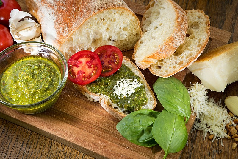 Fresh basil, pine nuts, garlic and olive oil are the main ingredients in fresh pesto. (Mike Siegel/Seattle Times/TNS)