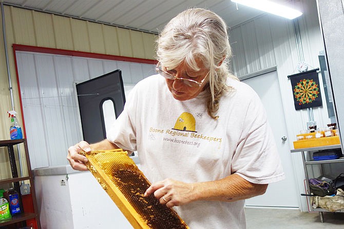 Nancy Giofre, co-owner and bee keeper for Giofre Apiaries, explains how she cares for the bees in her 100 hives. The Giofres hope to someday use exclusively home-produced honey in their ice creams.