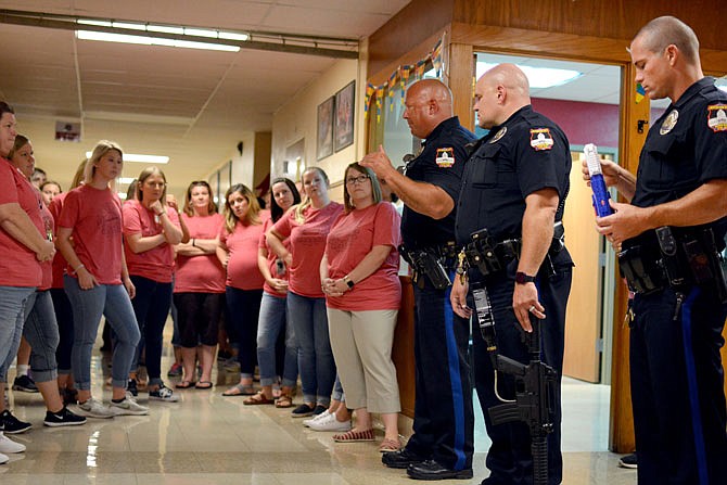 Jefferson City Police Department officers speak to faculty members Monday during active shooter training at Moreau Heights Elementary School. 