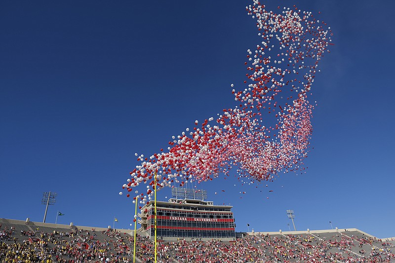 FILE- In this Oct. 14, 2017, file photo balloons are released in Memorial Stadium before an NCAA college football game between Indiana and Michigan in Bloomington, Ind. The celebration of releasing balloons into the air has long bothered environmentalists, who say the pieces that fall back to earth can be deadly to seabirds and turtles that eat them. So as companies vow to banish plastic straws, there are signs balloons are among the products getting more scrutiny.  (AP Photo/AJ Mast, File)