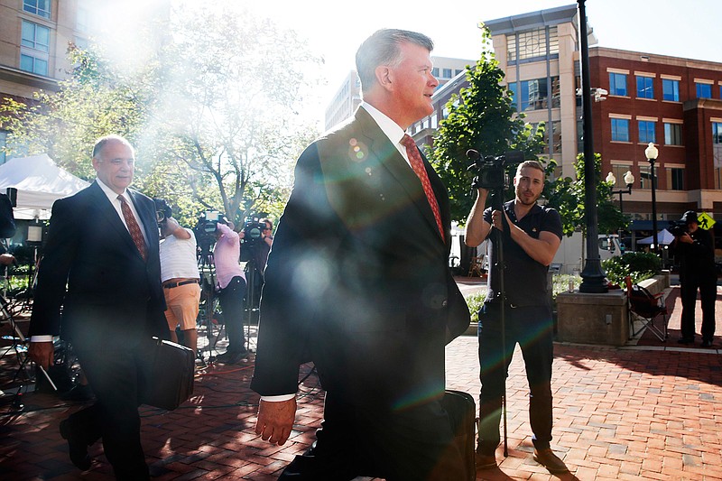 Attorney Thomas Zehnle, left, and Kevin Downing, walk with the defense team for Paul Manafort to federal court as the trial of the former Trump campaign chairman continues, in Alexandria, Va., Tuesday, Aug. 14, 2018. The focus in Paul Manafort's fraud trial shifts to the defense after prosecutors rested their case. (AP Photo/Jacquelyn Martin)