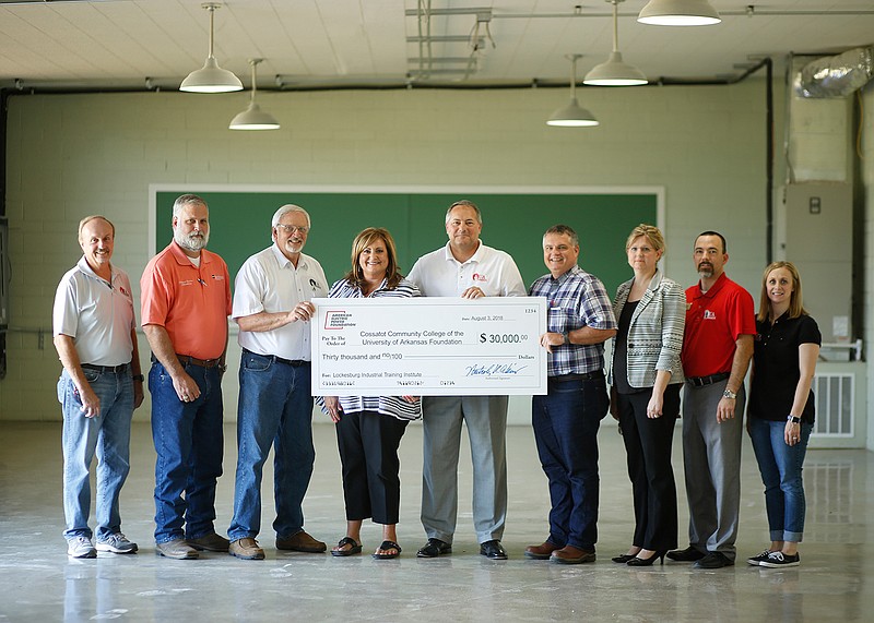 The American Electric Power Foundation recently donated $30,000 to the University of Arkansas Cossatot Foundation to purchase industrial technology training equipment for the Lockesburg Industrial Maintenance Institute. AEP Southwestern Electric Power Company Customer Service Representative Paul Knowles, Turk Plant Manager Tim Gross and External Affairs Manager Jennifer Harland presented the donation to UA Cossatot administrators. Accepting the donation is UA Cossatot Vice Chancellor of Facilities Mike Kinkade, Skilled and Technical Sciences Division Chair Steve McJunkins, Chancellor Steve Cole, Director of Public Services and Workforce Development Tammy Coleman, Ashdown Campus Director Barry Reed and Vice Chancellor of Academic Services Ashley Aylett. (Submitted photo)
