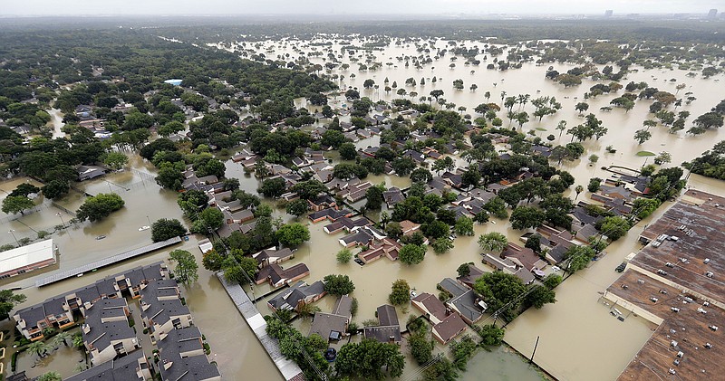 In this Tuesday, Aug. 29, 2017, file photo, a neighborhood near Houston's Addicks Reservoir is flooded after heavy rains from Tropical Storm Harvey. More than 300 Texas schools districts that helped educate Hurricane Harvey-displaced students are eligible to apply for $174 million in federal grants. The Texas Education Agency on Tuesday, Aug. 14, 2018, announced the assistance and a list of eligible districts and charter schools . The money comes from the Temporary Emergency Impact Aid for Displaced Students program. (AP Photo/David J. Phillip, File)