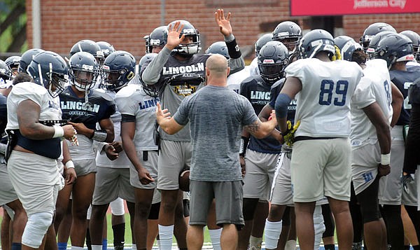 The Lincoln Blue Tigers prepare to go through a practice session Tuesday at Dwight T. Reed Stadium.