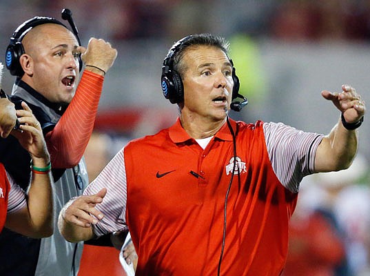 In this Sept. 17, 2016, file photo, Ohio State head coach Urban Meyer (right) and then-assistant coach Zach Smith gesture from the sideline during a game against Oklahoma in Norman, Okla.