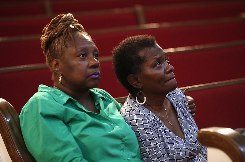 Leslie Mathews, left, and Emma Lockridge sit in New Bethel Baptist Church in Detroit, Thursday, Aug. 16, 2018. Aretha Franklin, the undisputed "Queen of Soul" who sang with matchless style on such classics as "Think," ''I Say a Little Prayer" and her signature song, "Respect," and stood as a cultural icon around the globe, died Thursday at age 76 from pancreatic cancer. C.L. Franklin, her father, had been pastor at the church that Franklin learned the gospel fundamentals that would make her a soul institution. (AP Photo/Paul Sancya)