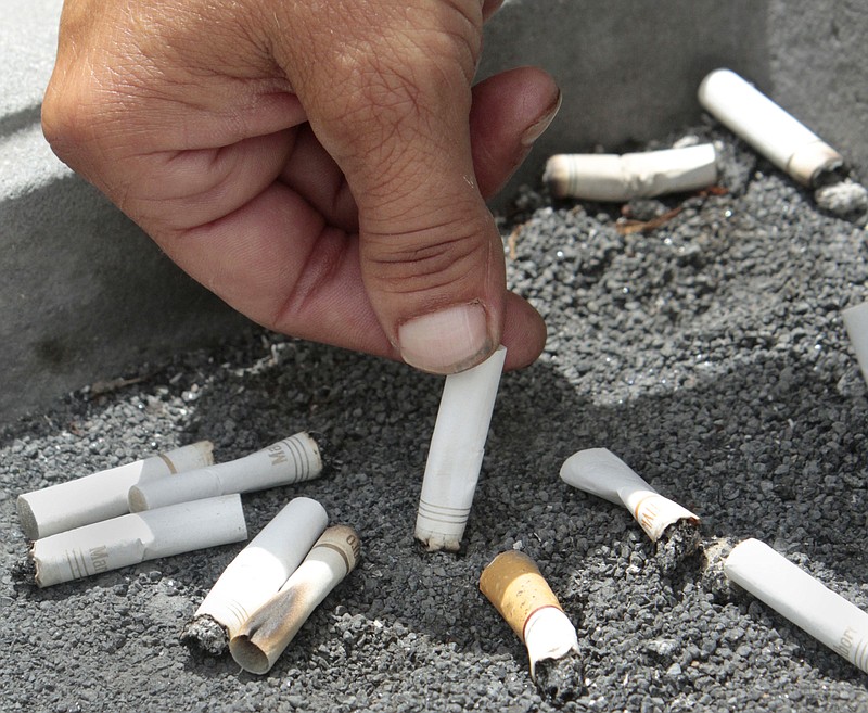 In this June 22, 2012 file photo, a smoker extinguishes a cigarette in an ash tray in Sacramento, Calif. If you quit smoking and gain weight, it may seem like you're trading one set of health problems for another. But a new U.S. study released on Wednesday, Aug. 15, 2018 finds you're still better off in the long run. (AP Photo/Rich Pedroncelli, File)