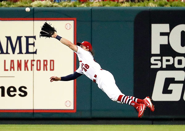 Cardinals center fielder Harrison Bader makes a diving catch on a fly ball hit by Bryce Harper of the Nationals during the fourth inning of Wednesday night's game at Busch Stadium in St. Louis.