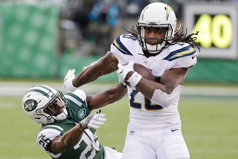 In this Sunday, Dec. 24, 2017 file photo, Los Angeles Chargers running back Melvin Gordon (28) breaks a tackle by New York Jets' Marcus Maye (26) during the second half of an NFL football game in East Rutherford, N.J.  Melvin Gordon got better as last season went on for the Los Angeles Chargers because he got healthier. The durable running back subsequently structured his offseason around staying fresh for another playoff chase, and he's already in top form in training camp. (AP Photo/Seth Wenig, File)