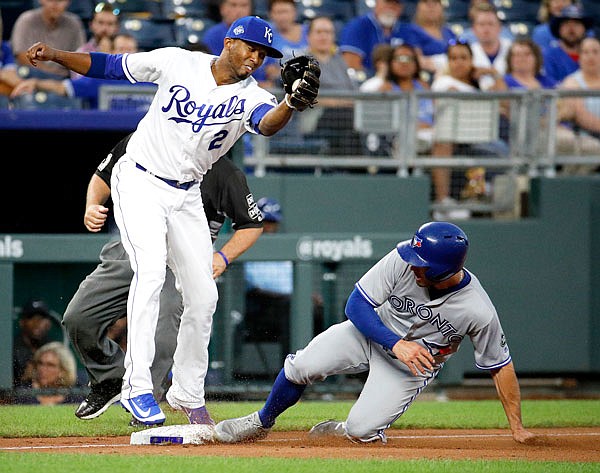 Randal Grichuk of the Blue Jays beats the tag by Royals third baseman Alcides Escobar to steal third base during the third inning of Wednesday night's game at Kauffman Stadium in Kansas City.