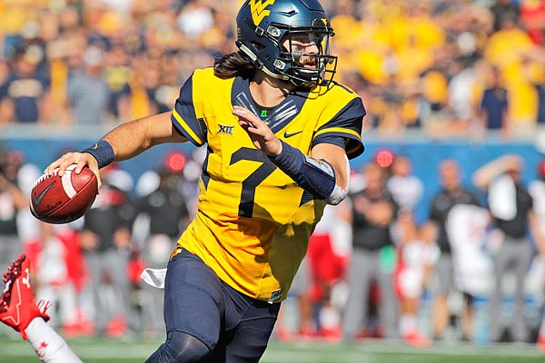 In this Oct. 14, 2017, file photo, West Virginia quarterback Will Grier looks to pass against Texas Tech during a game in Morgantown, W.Va.